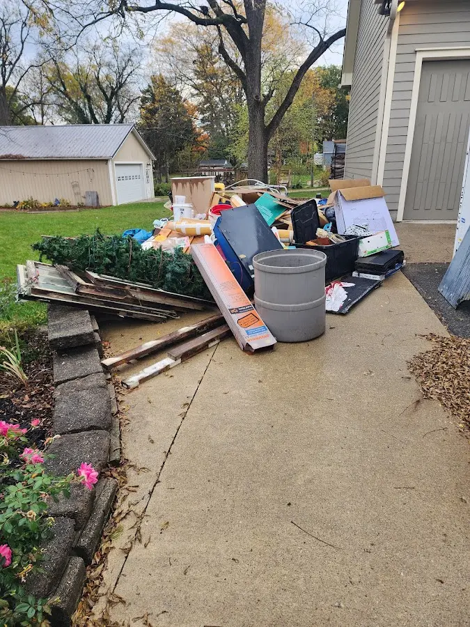 Dumpster being loaded with debris for 12 Yard Dumpster Rental in Coppell